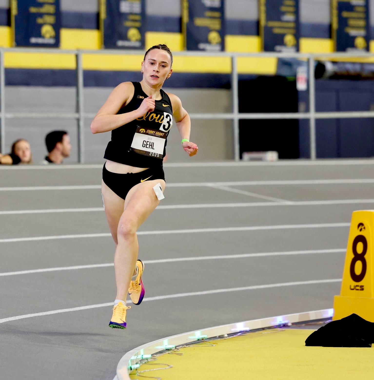 Runner moving around the curve with Stridelane lights visible on the inside lane