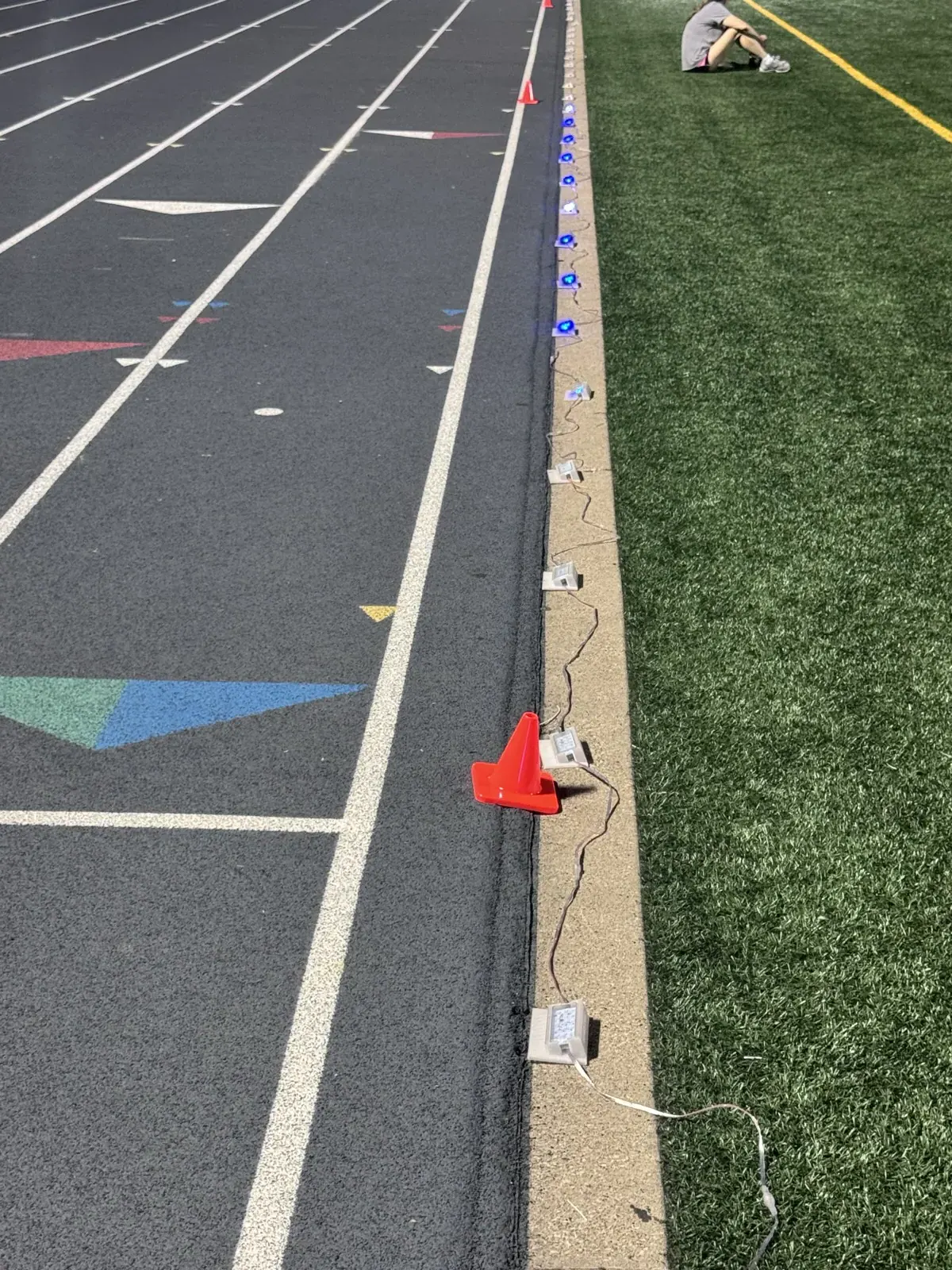 Stridelane lights and cabling set along an outdoor track rail