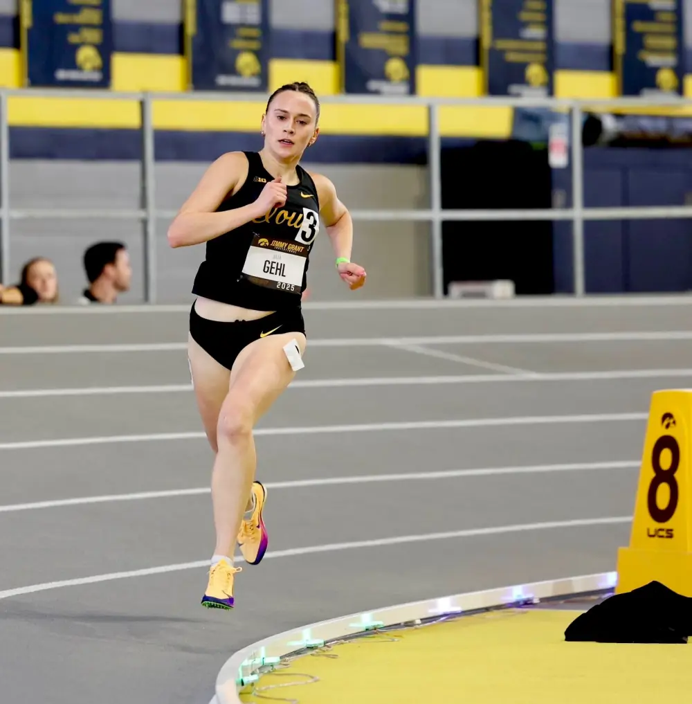 Runner moving around the curve with Stridelane lights visible on the inside lane